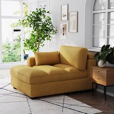 a living room with a yellow couch and potted plant