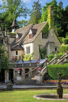 a large house with many windows and lots of greenery