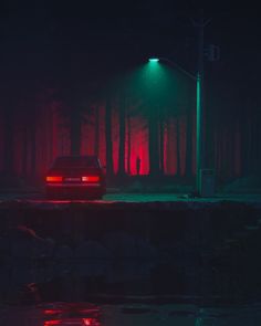 a car is parked on the side of a road in front of some trees at night