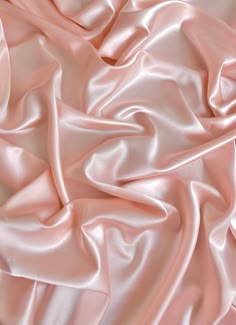 a close up view of a pink satin fabric