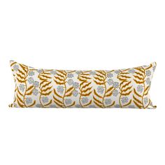 an orange and white pillow on a white background with gold trimmings in the shape of leaves