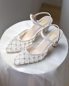 a pair of white shoes sitting on top of a table