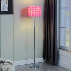 a pink floor lamp in a living room