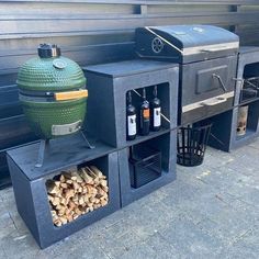 an outdoor bbq grill with firewood and wine bottles on the shelves next to it