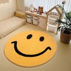 a smiley face rug on the floor in a child's room