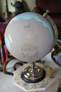 a globe with writing on it sitting on top of a table