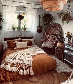 a bed room with a neatly made bed and lots of plants