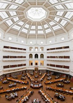 an overhead view of a library filled with lots of books and people sitting at tables