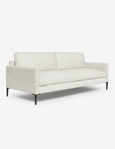 a white couch sitting on top of a white floor