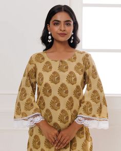 Get ready to make a statement with our Light Brown Cotton Block Printed Co-Ord Set! Made with premium cotton, this set features traditional Indian block print and crochet lace detailing for a touch of expert artistry. Plus, with convenient pockets, comfort and style go hand in hand. Perfect for any occasion! No. of pieces - 2 piece set. Color - Light Brown. Fabric - Cotton. Washing Instructions - Dry Clean. Printed Beige Sets For Festive Occasions, Bohemian Cotton Kurta With Printed Border, Fitted Cotton Lace Work Sets, Fitted Cotton Sets With Lace Work, Elegant Long Sleeve Block Print Sets, Traditional Cotton Block Print Tops, Beige Cotton Kurta For Festive Occasions, Traditional Cotton Sets With Lace Work, Cotton Lace Work Sets With Long Sleeves