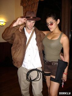 a man and woman are dressed up for an event, one is wearing a cowboy hat