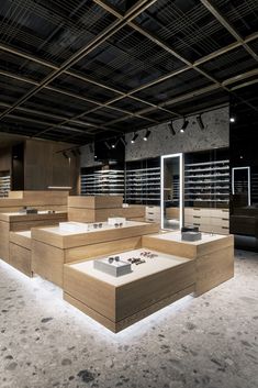 an empty store with lots of counter tops and lights on the ceiling, in dark lighting