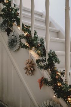 christmas garland on the banisters and handrails at the bottom of stairs