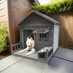 a white dog laying on top of a wooden house