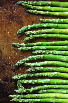 asparagus on a wooden cutting board ready to be cooked