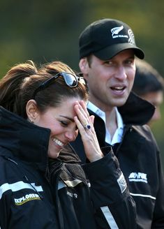 a man and woman standing next to each other with their hands on their foreheads