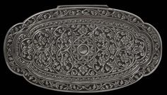 an intricately designed metal tray on a black background