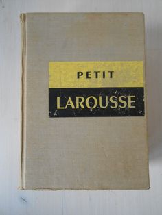 a book with the title peti larouse written in yellow and black on it