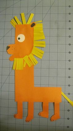 a paper cut out of a lion with yellow manes on it's head