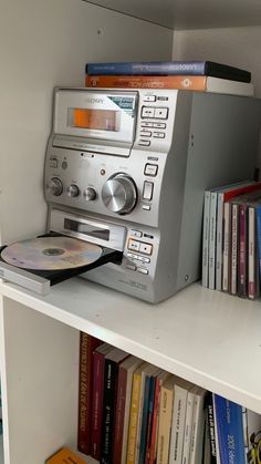 an old radio sitting on top of a book shelf