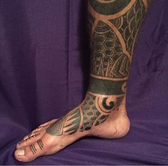 a man's foot with tattoos on it