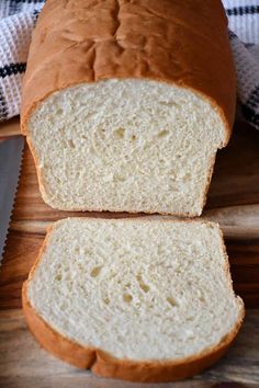 a loaf of bread sitting on top of a wooden cutting board