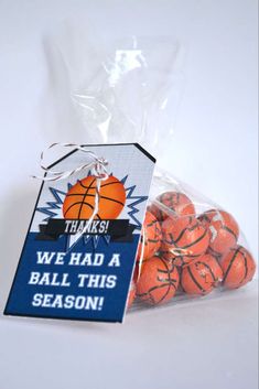 there is a bag of orange basketballs in front of the sign that says, thanks we had a ball this season