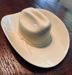 a white hat sitting on top of a wooden table