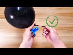 a person is using a screwdriver to fix a ball on a table with the word wnoo above it