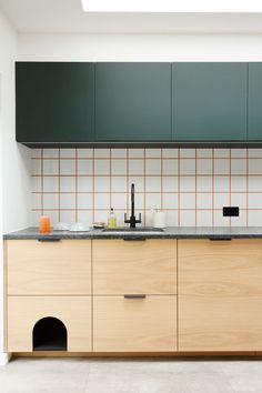 a kitchen with wooden cabinets and black counter tops