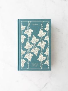 a blue book with white leaves on it