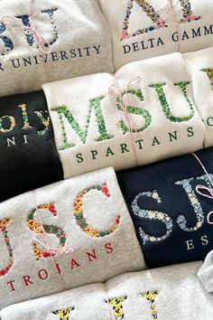 many different types of t - shirts with letters and numbers on them, all tied together