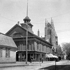 an old black and white photo of a building with a steeple on the top