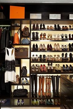 a closet filled with lots of shoes and purses next to a wall mounted shelf