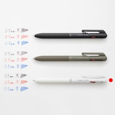 four different pens sitting next to each other on top of a white surface with chinese writing