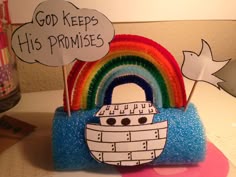 there is a paper boat with a rainbow in the middle and clouds above it that says god keeps his promises