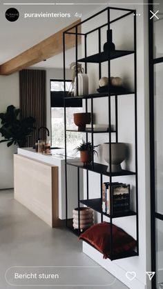 the shelves are filled with books and vases