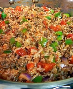 a pot filled with rice and vegetables on top of a stove