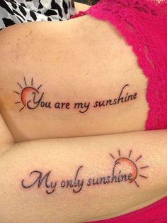 two girls with matching tattoos that say you are my sunshine and my only sunshine