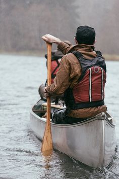 two people in a canoe paddling on the water