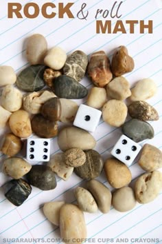 some rocks and two dices on a sheet of paper