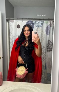 a woman taking a selfie in a bathroom mirror with a cupcake on the counter