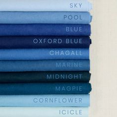 a stack of blue and white sheets with the names of different colors on them in various font styles