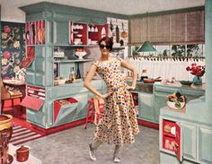 a woman in a dress is standing in a kitchen with an oven and stove top