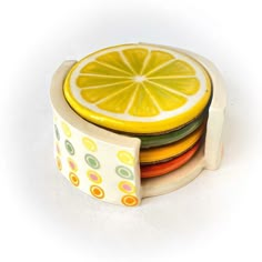 a stack of colorful plates with a slice of lemon on top of each plate in the middle