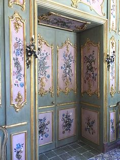 an ornately decorated room with green walls and gold trimmings on the doors