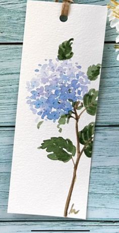 a blue flower is on a white card