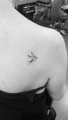 a woman with a bird tattoo on her back