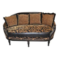 an animal print couch with black leather trim