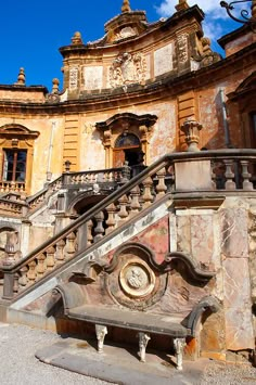 an old building with stairs leading up to it